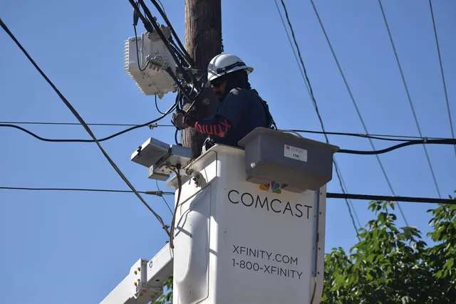 cable repairman, technician, comcast, xfinity, electrical wires, cat 5 cable, utility pole, service, installation, electrical cables, electricity, outage, installing, hard work, worker, hardhat, free pictures, 2023, 2024, men at work, houston texas, employment, working, job, dangerous work environment. Small business internet and telecom outages: evidence first