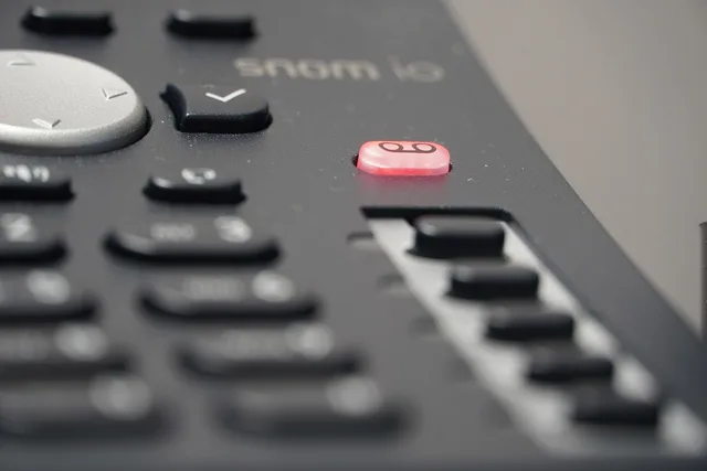 voicemail, desk phone, landline, telephone, phone, call, voip, gray phone, gray desk, gray telephone, voicemail, landline, voip, voip, voip, voip, voip. E911 rules for small business VoIP, explained for US employers