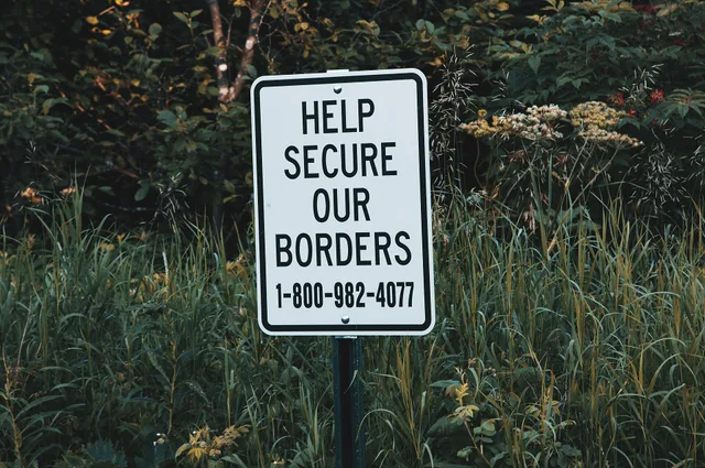 A sign reads "Help Secure Our Borders" with the toll-free number to report suspicious activity to U.S. Customs and Border Protection, 1-800-982-4077, at the Pigeon River boat launch just south of the Canadian border in Minnesota. - Copyright (c) 2018 Tony Webster tony@tonywebster.com +1 202-930-9200. Toll-free numbers: you pay for calls received, what the FCC capped, and 5 controls
